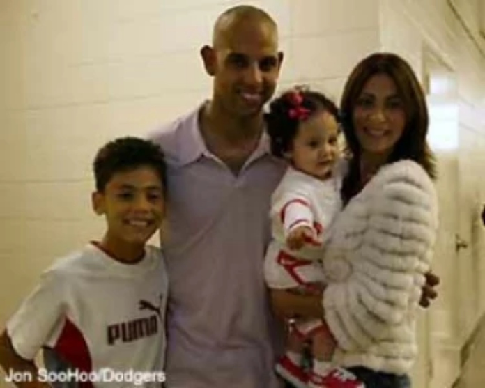 Alex Cora hugs his son Jeriel Cora and daughter Camila Cora with a