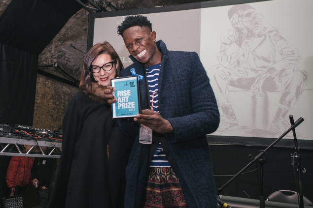 Nelson Makamo and Beatrice Hodgkin as he receives the Rise Art Prize 2018 Drawing Award