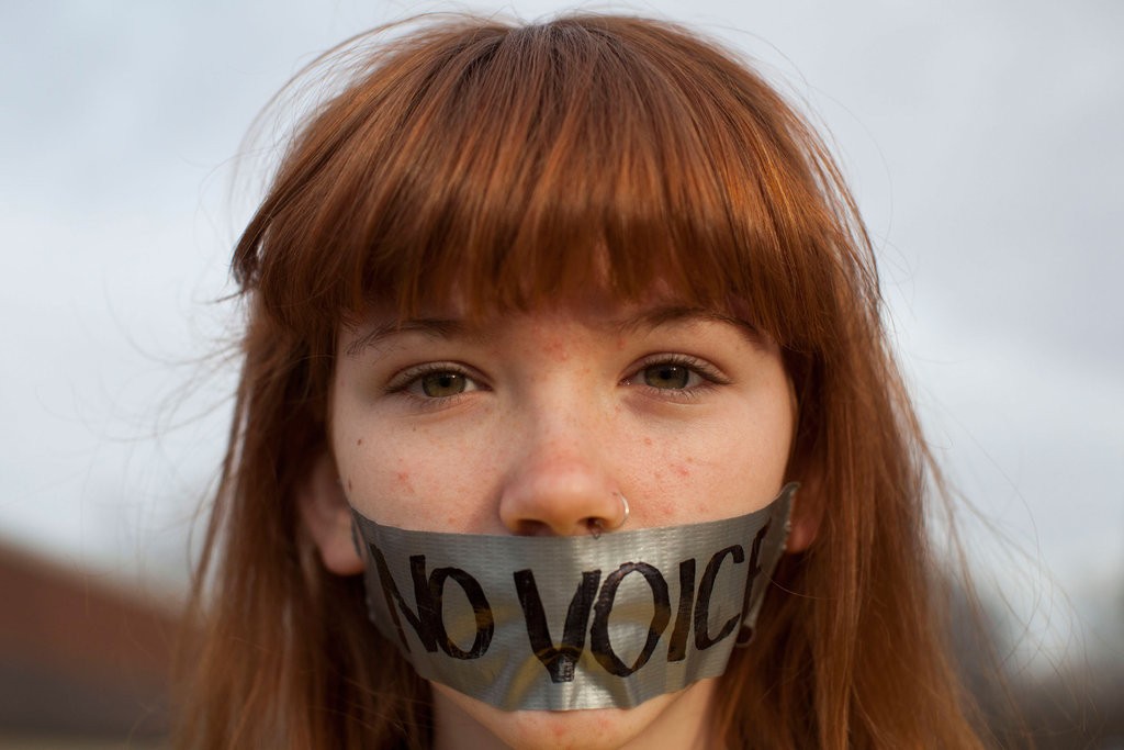 young-OWS-protestor-wore-tape-over-her-mouth-outside-Iowa